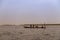 Fishermen collecting the nets in an old traditional fishing canoe near the island of Orango.