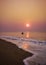 Fishermen coming back by boat to sea beach during early morning Sunrise time from the ocean.