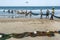 Fishermen drag a large fishing net onto the beach.