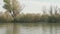 Fishermen fishing from speed motor boat near dry reeds on river. Eye angle view.