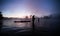 Fishermen holding fishing rod, standing in river