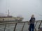 Fishermen on industrial pier on foggy day