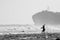 Fishermen nets fish on the beach, black and white color photo