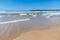 Fishermen pier, sand and waves