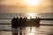 Fishermen preparing to go to work at sunset on a Colombian beach.