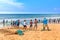 Fishermen pull a trawl with a catch on the beach on a sunny day