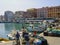 Fishermen repairing and preparing their nets on the quayside at Anzio, south of Rome, Italy.