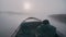 Fishermen ride the river in a boat in the fog in the morning