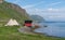 Fishermen`s cabins and lavvu, the traditional temporary dwelling of the Sami, northern Norway