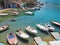 Fishermen`s huts carved into the rocky coast and boats moored on Milos Island