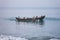 fishermen sail and sighting fish in traditional wooden canoe boat on blue indian ocean