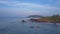 Fishermen sail on wooden boats along azure ocean upper