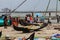 Fishermen sell the fish to customers against the backdrop of massive Chinese fishing nets