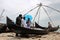 Fishermen sell the fish to customers against the backdrop of massive Chinese fishing nets