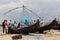 Fishermen sell the fish to customers against the backdrop of massive Chinese fishing nets