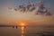 Fishermen silhouette on the beach at colorful sunset in Bali, In