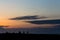 Fishermen silhouette on a sunset landscape on an orange sky