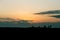 Fishermen silhouette on a sunset landscape on an orange sky in La Camargue, France