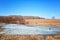 Fishermen sit on the ice pond