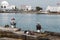 Fishermen sitting on a pierce at the sea port