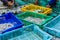 Fishermen sorting fish and squid in basket.