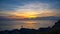 Fishermen standing on the rocks at sunset