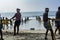 Fishermen Teamwork to pull the net from the ocean at the beach of Kovalam