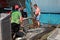 Fishermen unload the catch of sprat on small fishing boat