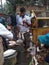 Fishermen weighing fish for sale . Fish market . Festival season .