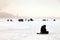 Fishermen on winter fishing with tents catch fish on the ice. Concept of male hobby, sport, passion, weekend in nature