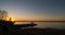 Fishermen on a wooden dock at sunrise on the lake