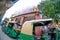 fisheye shot of chandni chowk with auto and electric rickshaw and fast food joint