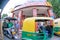 fisheye shot of chandni chowk with auto and electric rickshaw and fast food joint