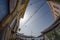 Fisheye shot of a flock of birds sitting on a wire above a backstreet in Greek town