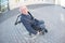 Fisheye view elderly man in wheelchair in urban setting