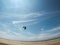Fisheye view of kiteboarder on beach