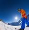 Fisheye view of smiling boy in ski mask skiing