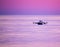 Fishing Boat Amid Violet Skies in the Gulf