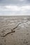 Fishing boat anchor chain stuck on the beach in low tide period.