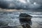 Fishing boat on the Baltic Sea shore. Dramatic stormy sky