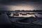 Fishing boat on the beach at sunrise with Alexandria skyline in far distance at sunrise