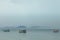 Fishing boat in the blue sea with blue sky and fog moutain background. Travel concept.