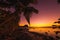 Fishing boat and coconut palm at sunset time. Le Morn mountain in Mauritius