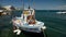 Fishing boat floating on water, drift nets lying on deck, small business