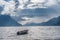 Fishing boat floating on water on fjord