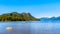 Fishing Boat heading into Pitt Lake with the Snow Capped Peaks of the Coast Mountain Range