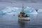 Fishing boat among icebergs in Disko Bay, West Greenland