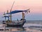 A fishing boat leaning on the beach looks aground