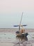 A fishing boat leaning on the beach looks aground