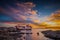 Fishing boat moored on the beach at sunset